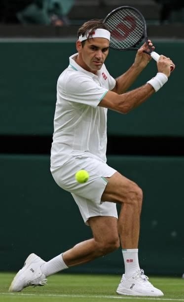 Switzerland's Roger Federer returns against France's Adrian Mannarino during their men's singles first round match on the second day of the 2021...