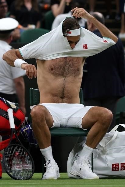 Switzerland's Roger Federer changes his shirt during a break in play against France's Adrian Mannarino during their men's singles first round match...