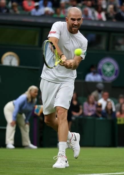 France's Adrian Mannarino returns against Switzerland's Roger Federer during their men's singles first round match on the second day of the 2021...