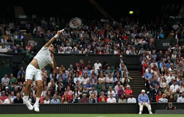 Switzerland's Roger serves returns against France's Adrian Mannarino during their men's singles first round match on the second day of the 2021...