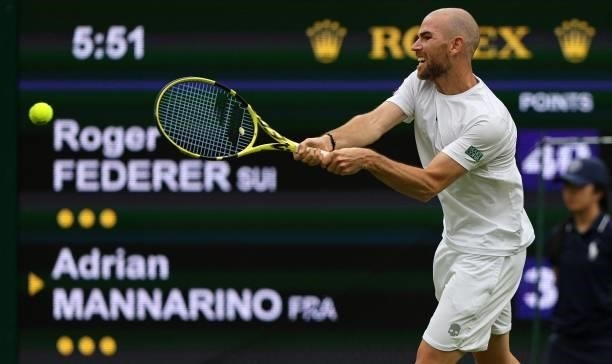 France's Adrian Mannarino returns against Switzerland's Roger Federer during their men's singles first round match on the second day of the 2021...