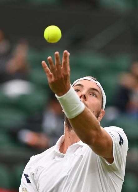 Germany's Jan-Lennard Struff serves to Russia's Daniil Medvedev during their men's singles first round match on the second day of the 2021 Wimbledon...