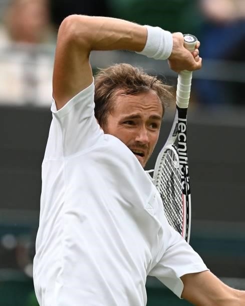 Russia's Daniil Medvedev returns to Germany's Jan-Lennard Struff during their men's singles first round match on the second day of the 2021 Wimbledon...