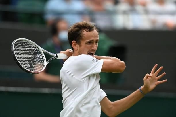 Russia's Daniil Medvedev returns to Germany's Jan-Lennard Struff during their men's singles first round match on the second day of the 2021 Wimbledon...