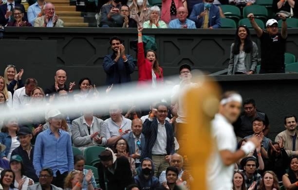 The crowd applauds Switzerland's Roger Federer after he won the a point in the fourth set against France's Adrian Mannarino during their men's...