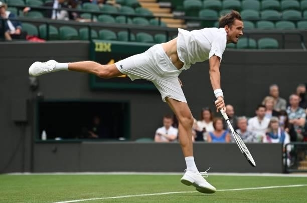 Russia's Daniil Medvedev serves to Germany's Jan-Lennard Struff during their men's singles first round match on the second day of the 2021 Wimbledon...