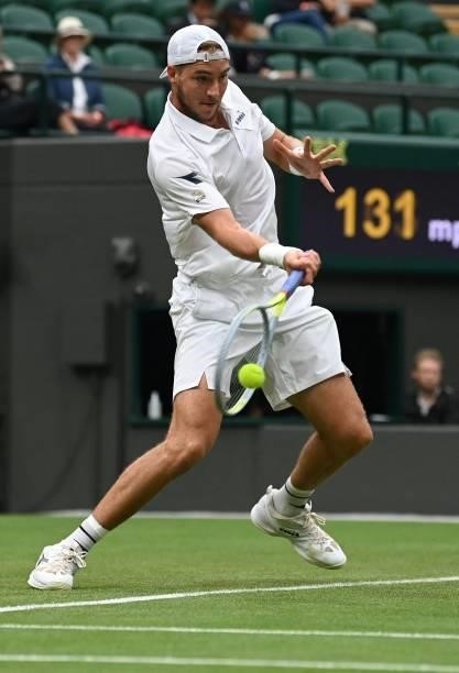 Germany's Jan-Lennard Struff returns to Russia's Daniil Medvedev during their men's singles first round match on the second day of the 2021 Wimbledon...