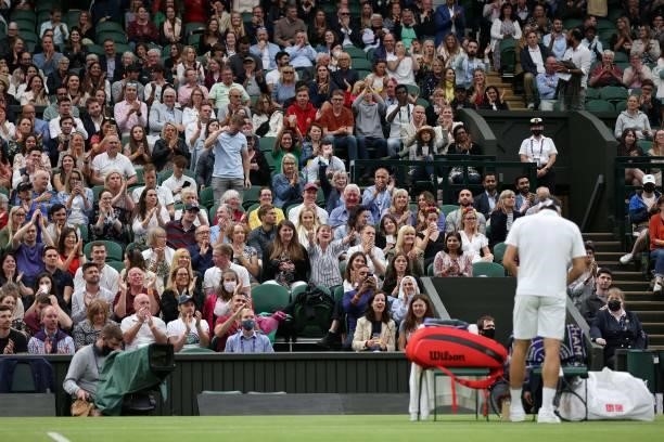 The crowd applauds Switzerland's Roger Federer after he won the first game of the fourth set against France's Adrian Mannarino during their men's...