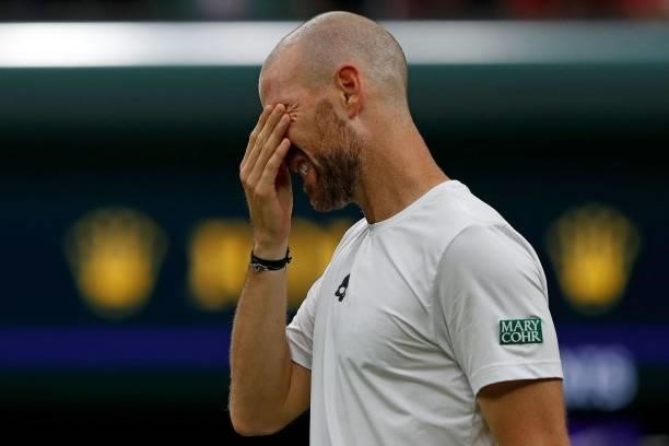 France's Adrian Mannarino reacts as he withdraws from his men's singles first round match against Switzerland's Roger Federer, on the second day of...