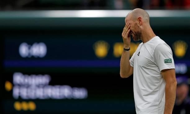 France's Adrian Mannarino reacts as he withdraws from his men's singles first round match against Switzerland's Roger Federer, on the second day of...