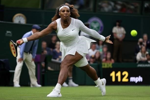 Player Serena Williams returns against Belarus's Aliaksandra Sasnovich during their women's singles first round match on the second day of the 2021...