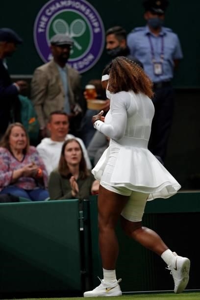 Player Serena Williams, wearing a face covering to combat the spread of coronavirus, leaves the court for treatment during her women's singles first...