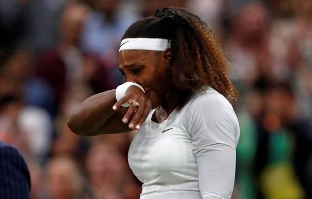Player Serena Williams reacts as she withdraws from her women's singles first round match against Belarus's Aliaksandra Sasnovich on the second day...