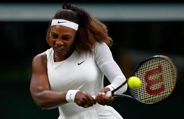 Player Serena Williams returns against Belarus's Aliaksandra Sasnovich during their women's singles first round match on the second day of the 2021...