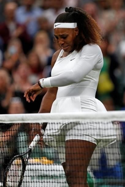 Player Serena Williams reacts as she withdraws from her women's singles first round match against Belarus's Aliaksandra Sasnovich on the second day...