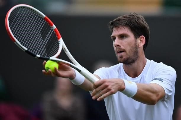 Britain's Cameron Norrie serves to France's Lucas Pouille during their men's singles first round match on the second day of the 2021 Wimbledon...
