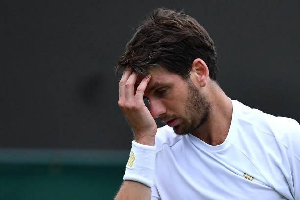 Britain's Cameron Norrie reacts while playing France's Lucas Pouille during their men's singles first round match on the second day of the 2021...