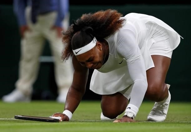Player Serena Williams reacts as she pulls-up injured before withdrawing from her women's singles first round match against Belarus's Aliaksandra...