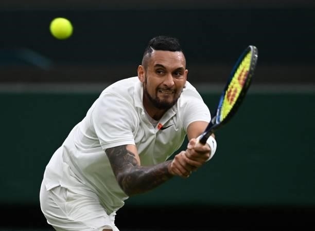 Australia's Nick Kyrgios returns to France's Ugo Humbert during their men's singles first round match on the second day of the 2021 Wimbledon...
