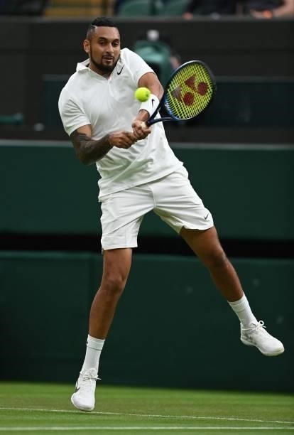 Australia's Nick Kyrgios returns to France's Ugo Humbert during their men's singles first round match on the second day of the 2021 Wimbledon...
