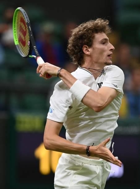 France's Ugo Humbert returns to Australia's Nick Kyrgios during their men's singles first round match on the second day of the 2021 Wimbledon...