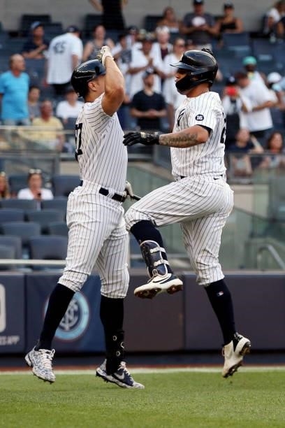 Gary Sánchez of the New York Yankees is greeted by teammate Giancarlo Stanton after hitting a solo home run in the first inning during the game...