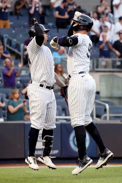Aaron Judge of the New York Yankees is greeted by teammate Gary Sanchez a two-run home run in the second inning during the game between the Los...