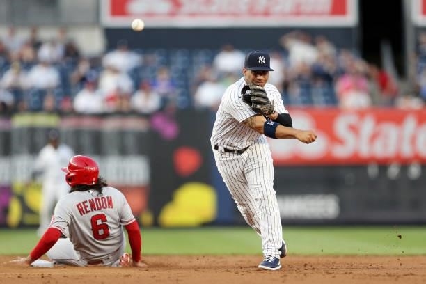 Gleyber Torres of the New York Yankees turns a double play as Anthony Rendon of the Los Angeles Angels slides into second base during the game at...