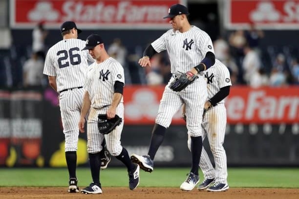 Aaron Judge, DJ LeMahieu and Brett Gardner of the New York Yankees celebrate after the Yankees defeated the Los Angeles Angels at Yankee Stadium on...