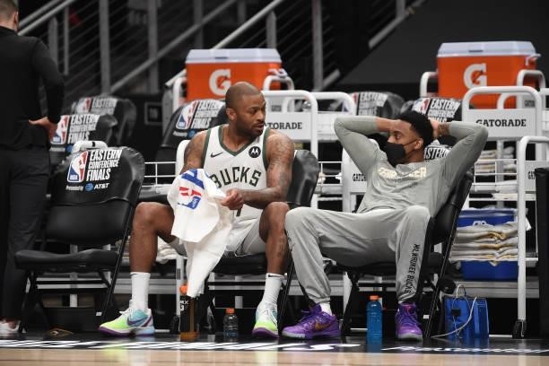 Tucker of the Milwaukee Bucks and Jeff Teague of the Milwaukee Bucks talk during Game 4 of the Eastern Conference Finals of the 2021 NBA Playoffs on...
