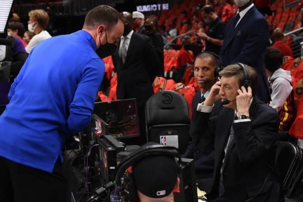 Referee Josh Tiven talks to Former NBA Player and Commentator Reggie Miller, and Sportscaster, Marv Albert, during Game 4 of the Eastern Conference...