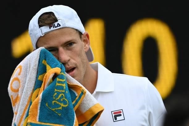 Argentina's Diego Schwartzman uses a towel during a break in play against Britain's Liam Broady during their men's singles second round match on the...