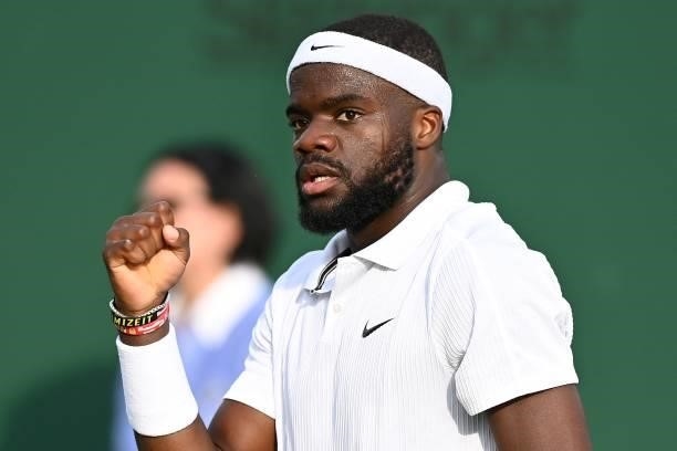 Player Frances Tiafoe reacts against Canada's Vasek Pospisil during his men's singles second round match on the third day of the 2021 Wimbledon...