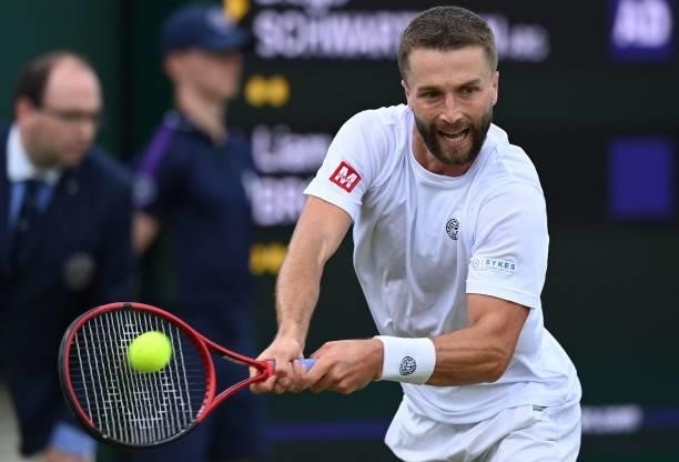 Britain's Liam Broady returns against Argentina's Diego Schwartzman during their men's singles second round match on the third day of the 2021...