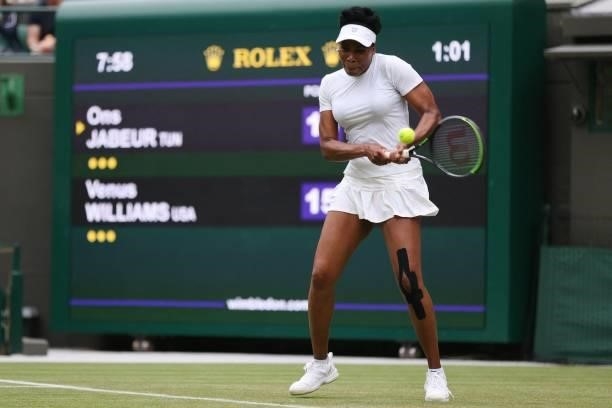 Player Venus Williams returns to Tunisia's Ons Jabeur during their women's singles second round match on the third day of the 2021 Wimbledon...