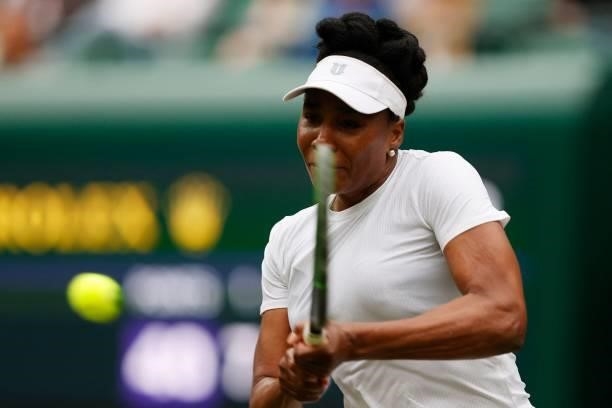 Player Venus Williams returns to Tunisia's Ons Jabeur during their women's singles second round match on the third day of the 2021 Wimbledon...