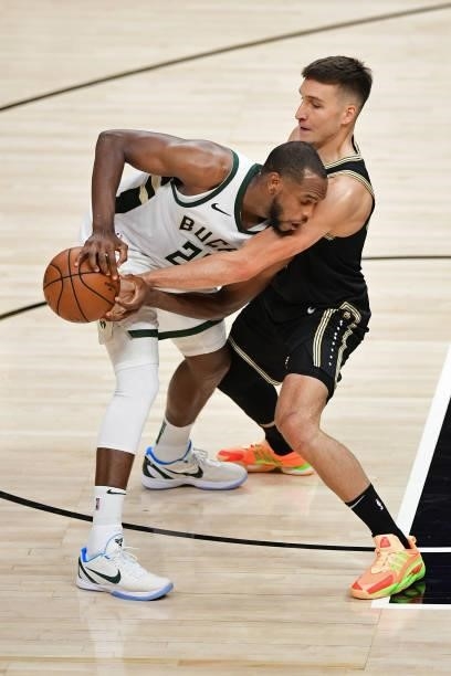 JuNE 29: Bogdan Bogdanovic of the Atlanta Hawks steals the ball from Khris Middleton of the Milwaukee Bucks during Game 4 of the Eastern Conference...