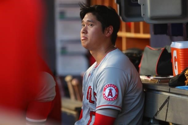 Shohei Ohtani of the Los Angeles Angels reacts in the dugout after leaving the game in the bottom of the first inning during the game between the Los...