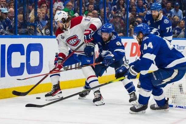 Tyler Johnson and Jan Rutta of the Tampa Bay Lightning battle against Josh Anderson of the Montreal Canadiens during the second period of Game Two of...
