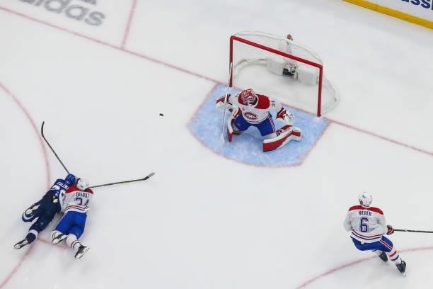 Blake Coleman of the Tampa Bay Lightning shoots the puck into the net for a goal against goalie Carey Price and Phillip Danault of the Montreal...