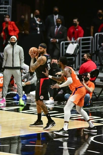 DeMarcus Cousins of the LA Clippers handles the ball as Deandre Ayton of the Phoenix Suns plays defense during Game 6 of the Western Conference...