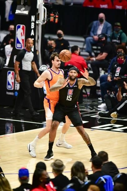 DeMarcus Cousins of the LA Clippers handles the ball as Dario Saric of the Phoenix Suns plays defense during Game 6 of the Western Conference Finals...