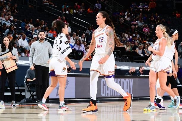 Brittney Griner of the Phoenix Mercury high fives her teammate during the game against the Minnesota Lynx on June 30, 2021 at Phoenix Suns Arena in...