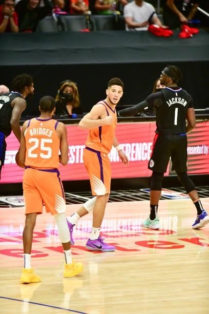 Devin Booker of the Phoenix Suns talks to Mikal Bridges of the Phoenix Suns during the game against the LA Clippers during Game 6 of the Western...