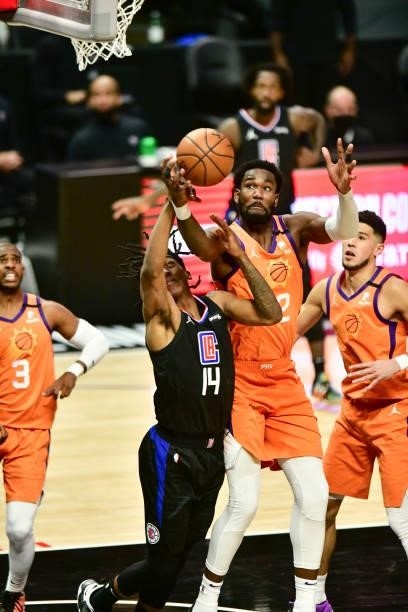 Terance Mann of the LA Clippers and Deandre Ayton of the Phoenix Suns fight for the rebound during the game during Game 6 of the Western Conference...