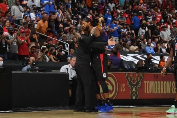 Paul George of the LA Clippers hugs Head Coach Tyronn Lue of the Los Angeles Clippers during Game 6 of the Western Conference Finals of the 2021 NBA...