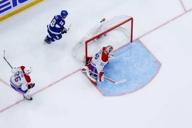 Ondrej Palat of the Tampa Bay Lightning watches the puck go into the net for a goal against goalie Carey Price of the Montreal Canadiens during the...
