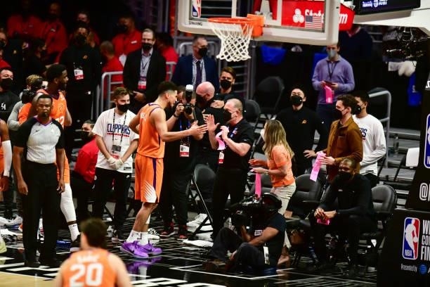 Devin Booker of the Phoenix Suns high fives Owner, Robert Sarver of the Phoenix Suns during the game against the LA Clippers during Game 6 of the...