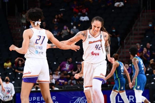 Brittney Griner of the Phoenix Mercury high fives her teammate during the game against the Minnesota Lynx on June 30, 2021 at Phoenix Suns Arena in...