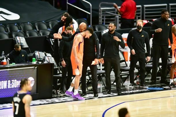 Head Coach Monty Williams of the Phoenix Suns hugs Devin Booker of the Phoenix Suns during the game against the LA Clippers during Game 6 of the...